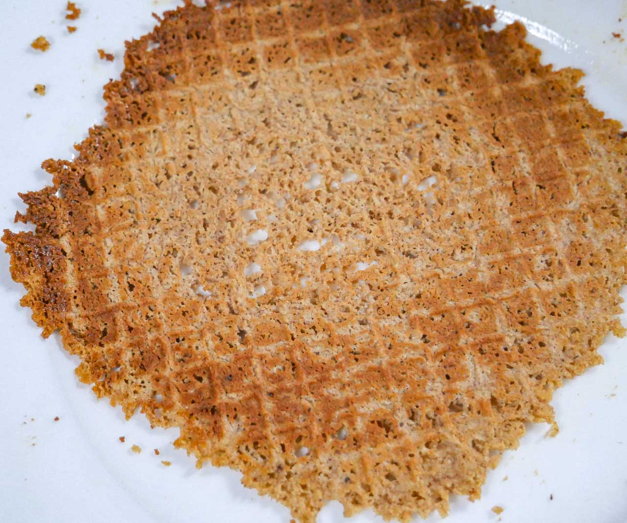 Homemade gingerbread waffle on a plate cooling for 10 seconds