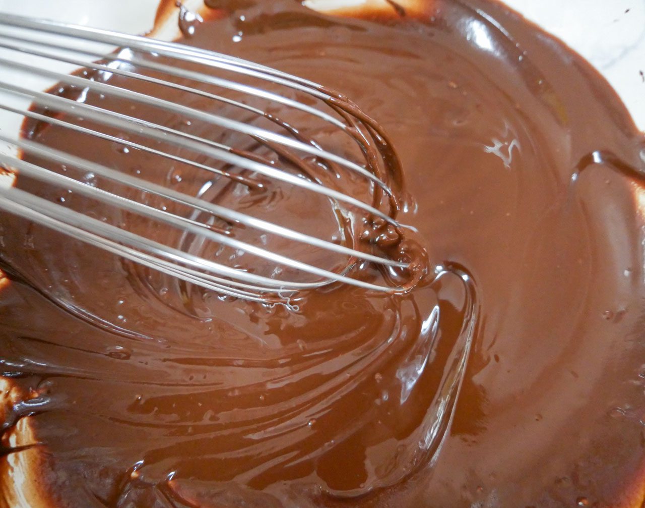 Chocolate melted and whisked in a bowl
