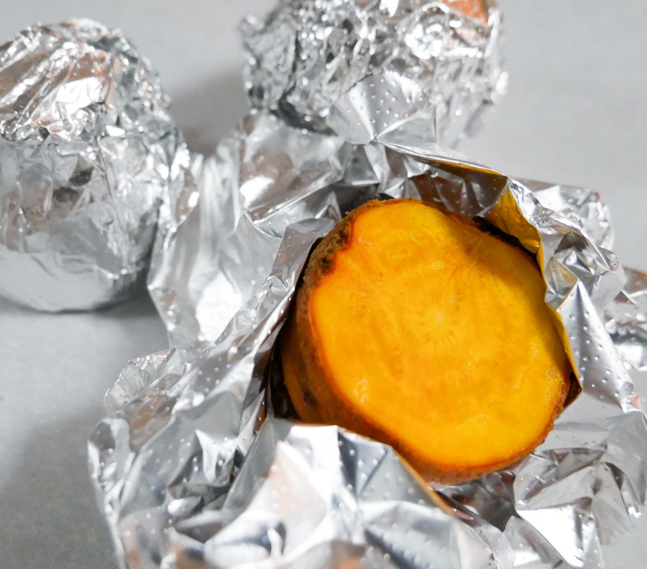 Golden beets wrapped in foil before going into oven