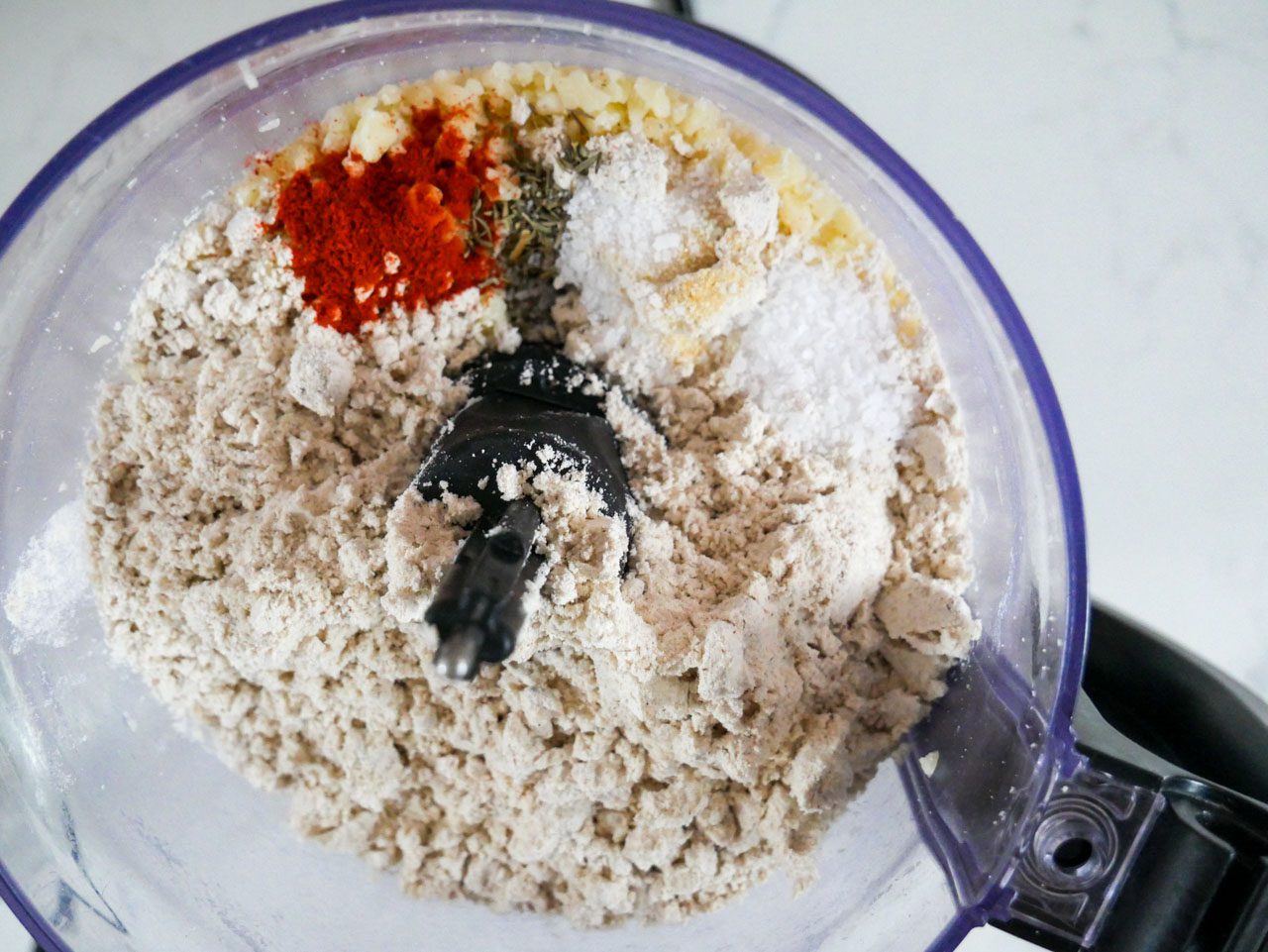 Tiger nut flour, spices, and crumbled cheese in food processor 
