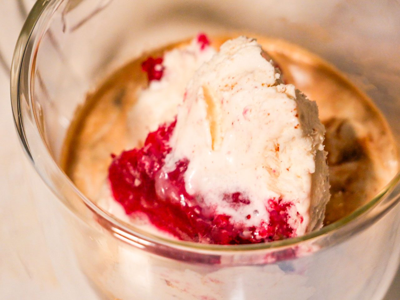Cranberry Sauce ice cream scoop in a coffee in a clear mug. 