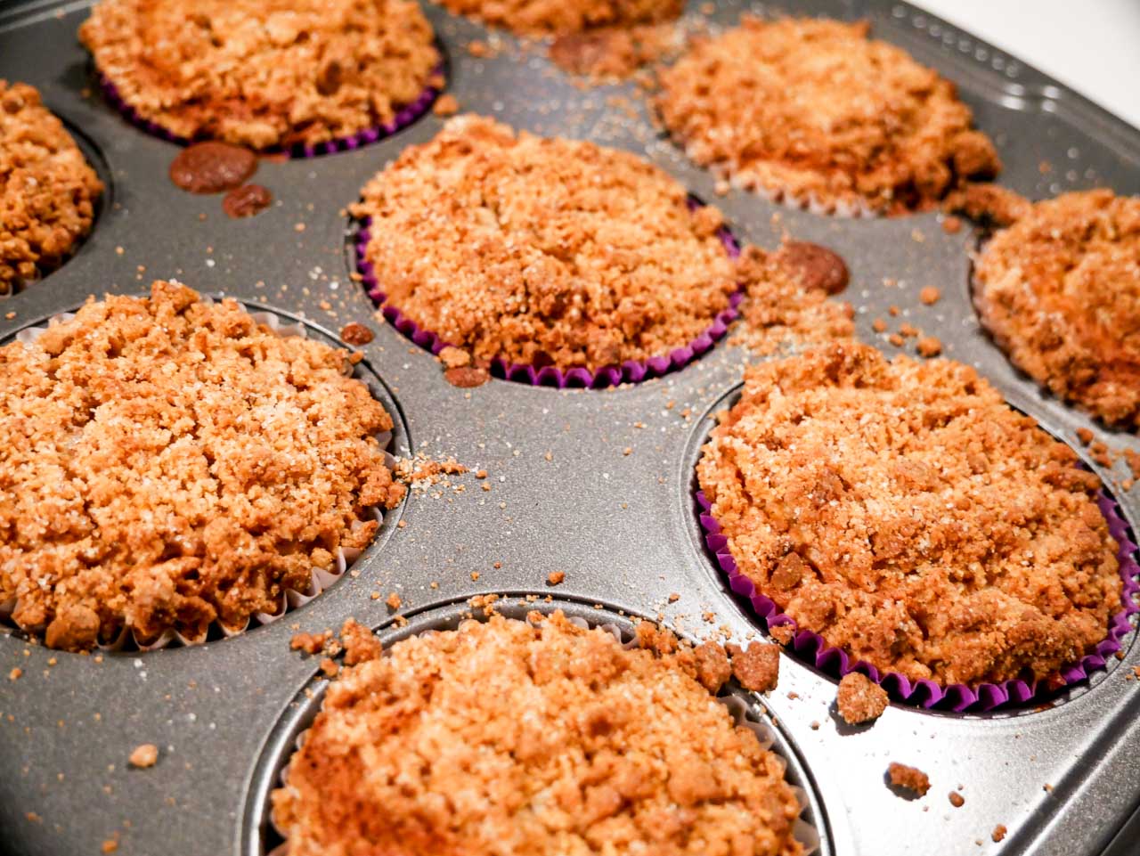 Baked plum muffins with crumble out of the oven