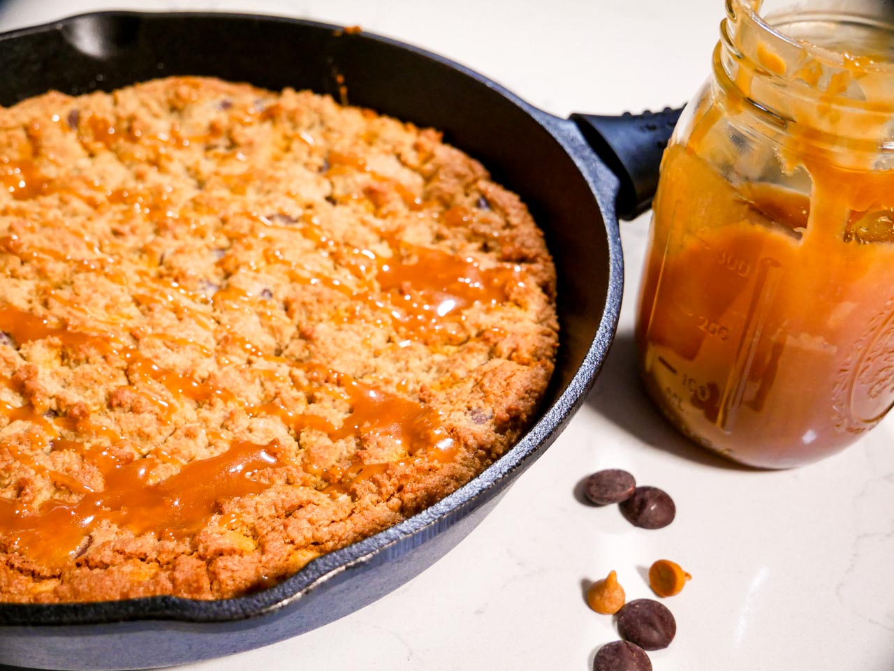 Salted Caramel Cookie Skillet with butterscotch chips in a cast iron skillet 